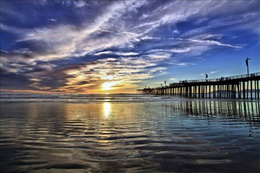 Reflections of the Pismo Beach Pier on a silvery beach.